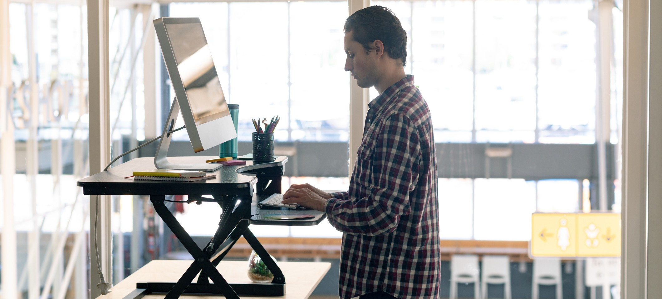 Person working on a computer at a raised desk